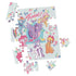 My Little Pony jigsaw puzzle featuring pastel multicolor cardboard pieces in interlocking shapes, showing cartoon ponies and flowers on a light blue background, partially assembled on a flat surface.