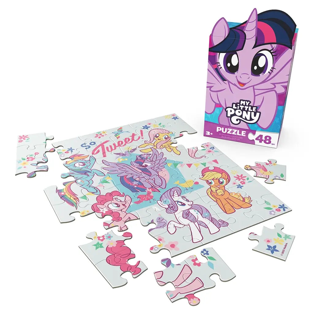 My Little Pony puzzle set with pastel cardboard pieces in interlocking shapes, showing ponies and floral graphics, alongside upright branded box on a clean white background display setting.