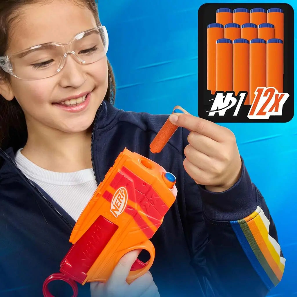 NERF N-Series dart blaster scene with a child in safety goggles loading a small orange foam dart into the bright orange and red toy, while an inset graphic highlights the included twelve refill darts.