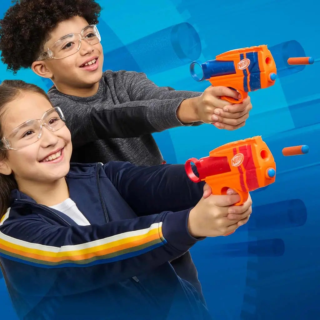 NERF N-Series dart blasters lifestyle image with two smiling kids wearing clear safety glasses, holding orange launchers aimed forward as foam darts fire against a dynamic blue background with motion effects.