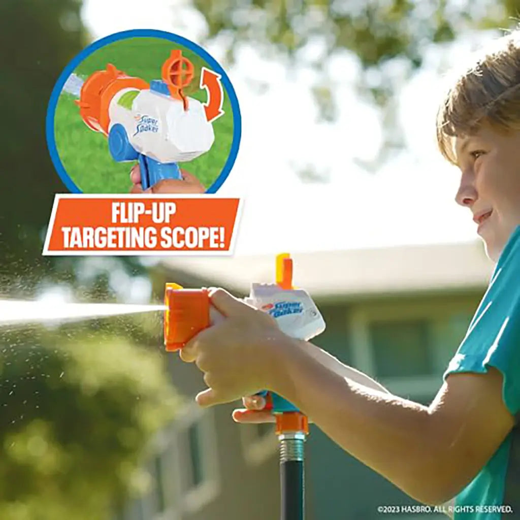 Nerf Super Soaker Quadblast being used by a child outdoors, spraying water with an inset showing the blaster’s bright orange flip-up targeting scope feature for improved water aiming accuracy.