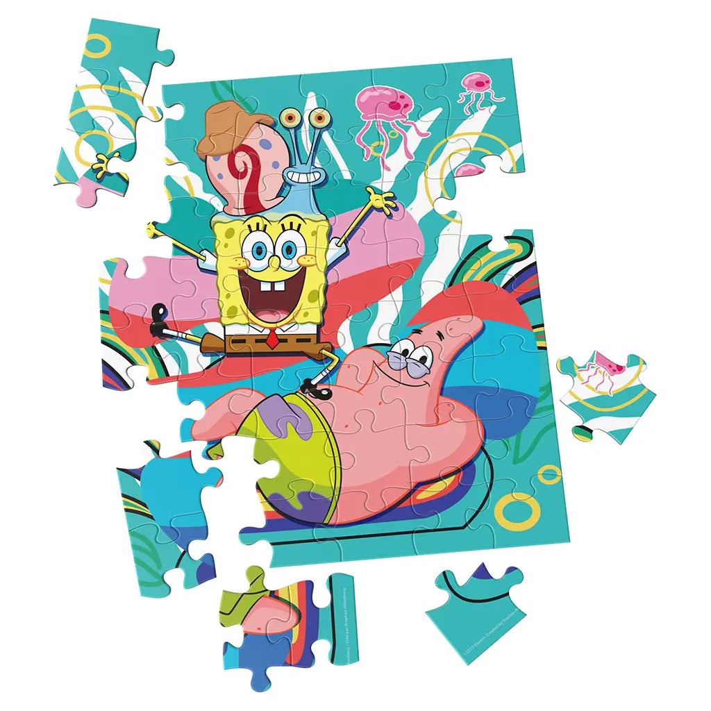 bright cardboard jigsaw puzzle Nickelodeon SpongeBob SquarePants, smooth interlocking pieces in vivid blue, yellow, and pink forming SpongeBob and Patrick scene, partially assembled on a clean white background
