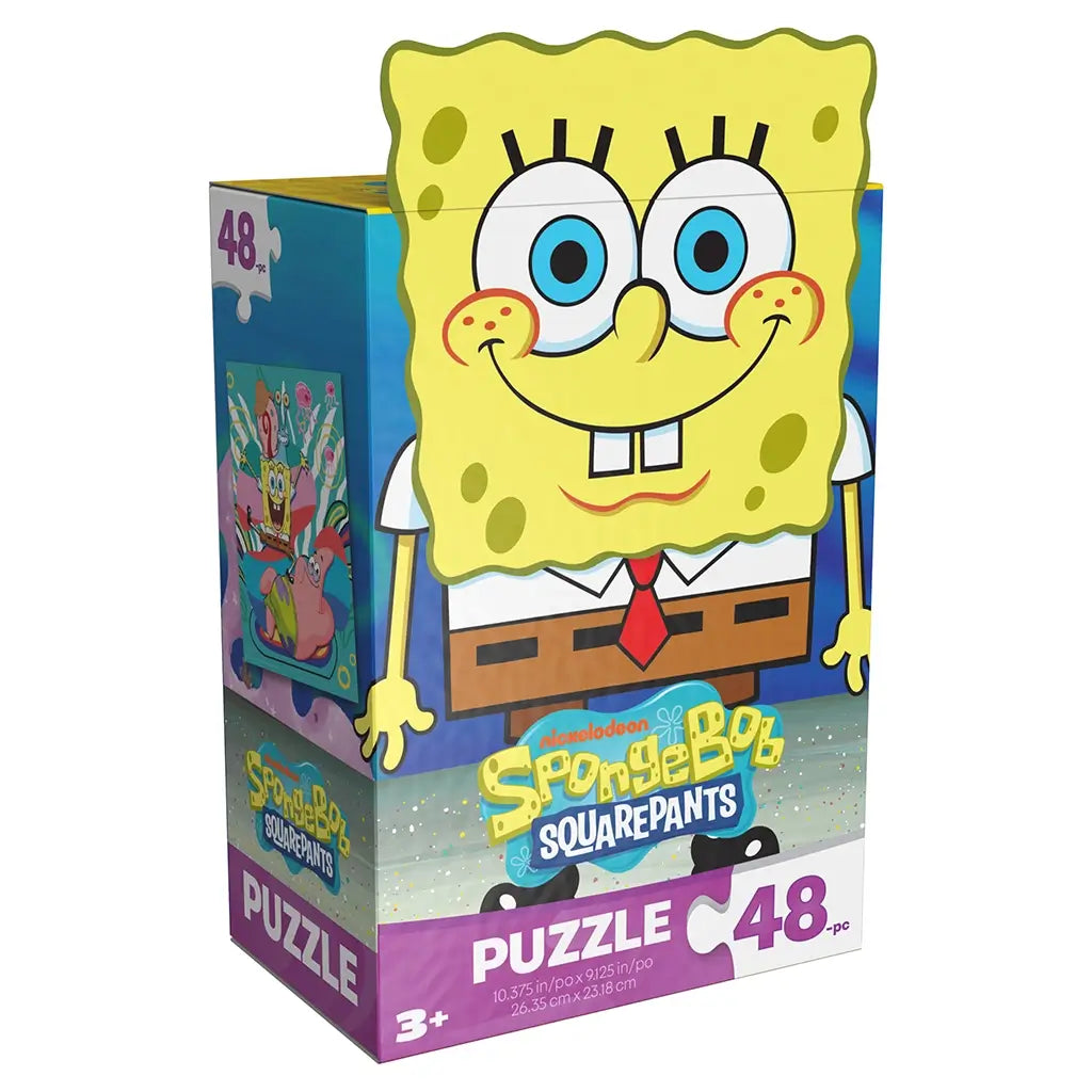 yellow cardboard puzzle box Nickelodeon SpongeBob SquarePants, glossy printed surface with large character face, rectangular angled packaging showing 48 piece label on a clean white background