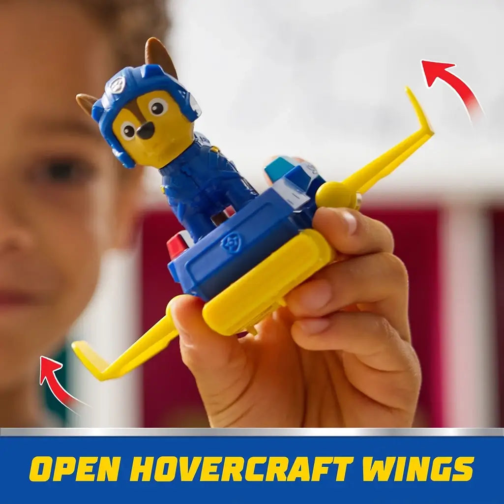 Child holds PAW Patrol Chase figure in blue and yellow hoverboard with extended wings, demonstrating interactive flying feature for creative play.