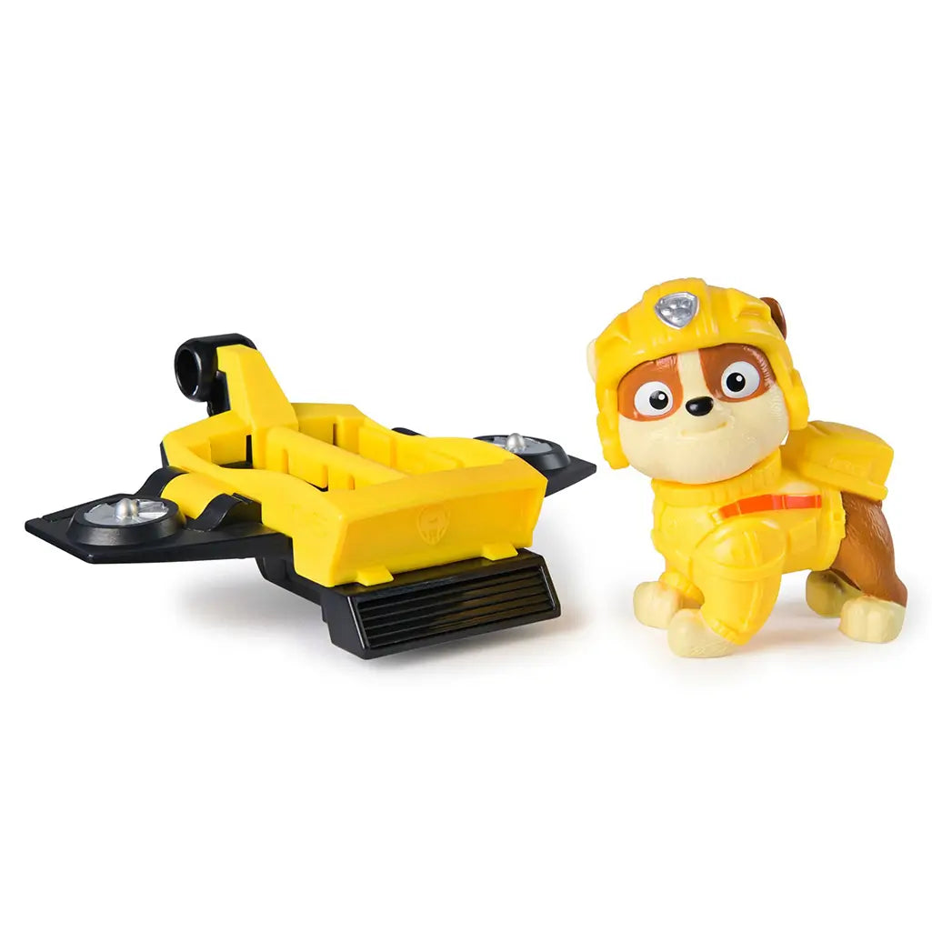 PAW Patrol Rubble figure in bright yellow outfit displayed beside yellow and black hoverboard, showcasing detachable toy components for imaginative play.