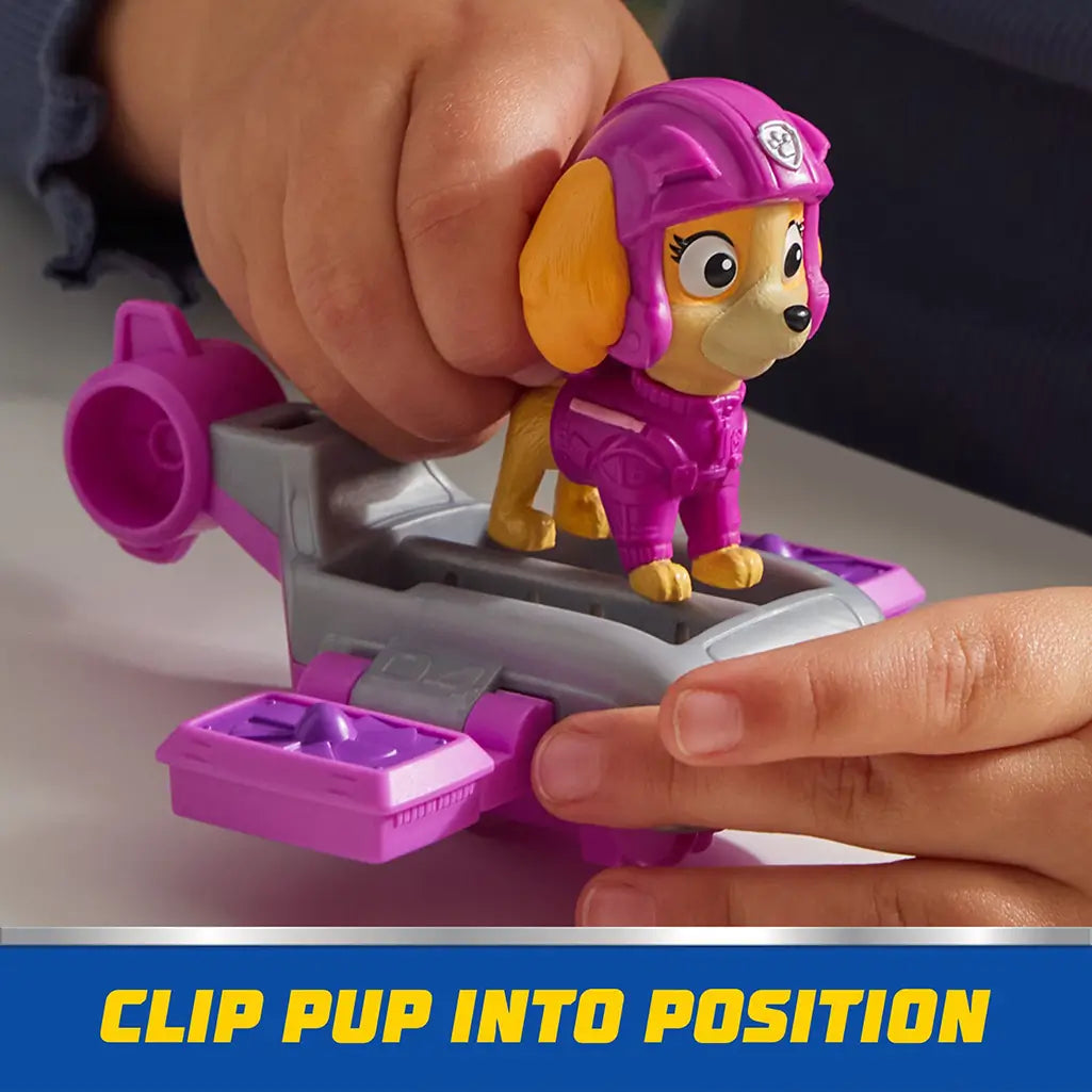 Child secures PAW Patrol Skye figure into pink and gray hoverboard base, demonstrating how the pup clips into position for stable play.