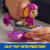 Child secures PAW Patrol Skye figure into pink and gray hoverboard base, demonstrating how the pup clips into position for stable play.