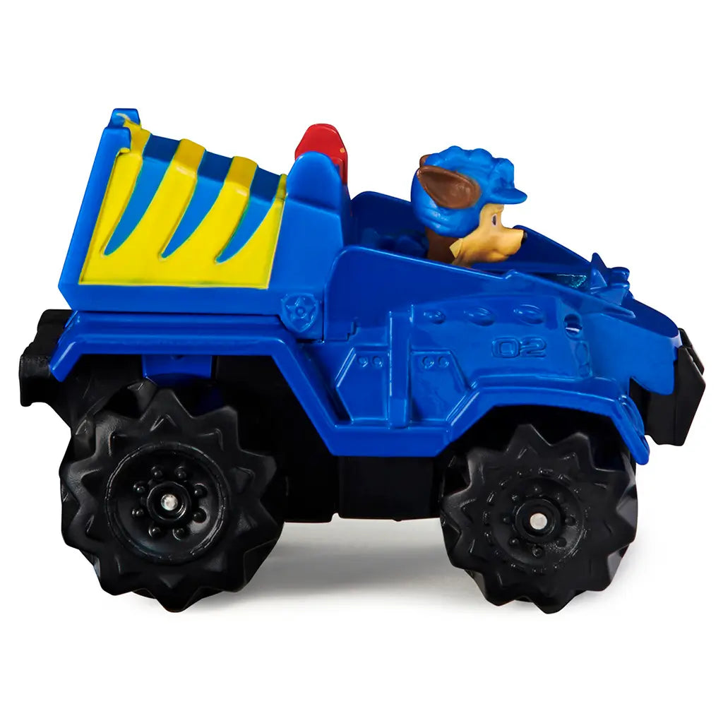 Blue die-cast Paw Patrol Chase Dino Rescue truck with smooth plastic body, rugged off-road shape, yellow rear detail, and black wheels in side profile on white background.