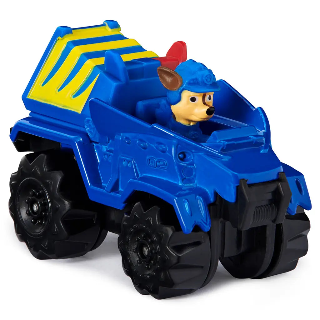 Blue die-cast Paw Patrol Chase Dino Rescue truck with smooth plastic finish, chunky off-road shape, yellow cargo detail, and black wheels shown at an angled view on white background.