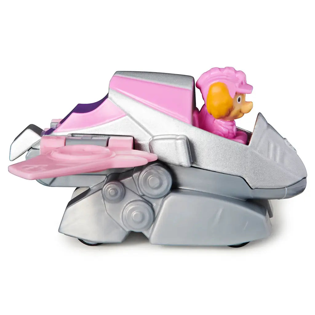 Paw Patrol Skye Dino Rescue toy vehicle in pink and silver plastic and metal textures, compact jet-inspired car shape with wings, side view showing wheels and details on a clean white background.