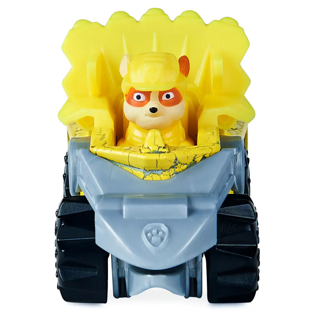 Paw Patrol Rubble toy truck front view in bright yellow metal and plastic, compact wide form with gray scoop and large black tires, built for construction rescue play on a plain white backdrop