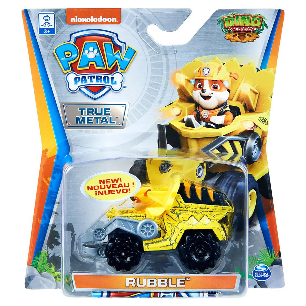 Paw Patrol Rubble toy truck package in bright yellow plastic and clear blister, angular carded form with Nickelodeon logo and Dino Rescue theme, displayed on retail shelf-style background