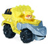 Paw Patrol Rubble toy truck in bright yellow die-cast metal and plastic, chunky angular dump truck form with black wheels and gray scoop arm, designed for construction play on a clean white background