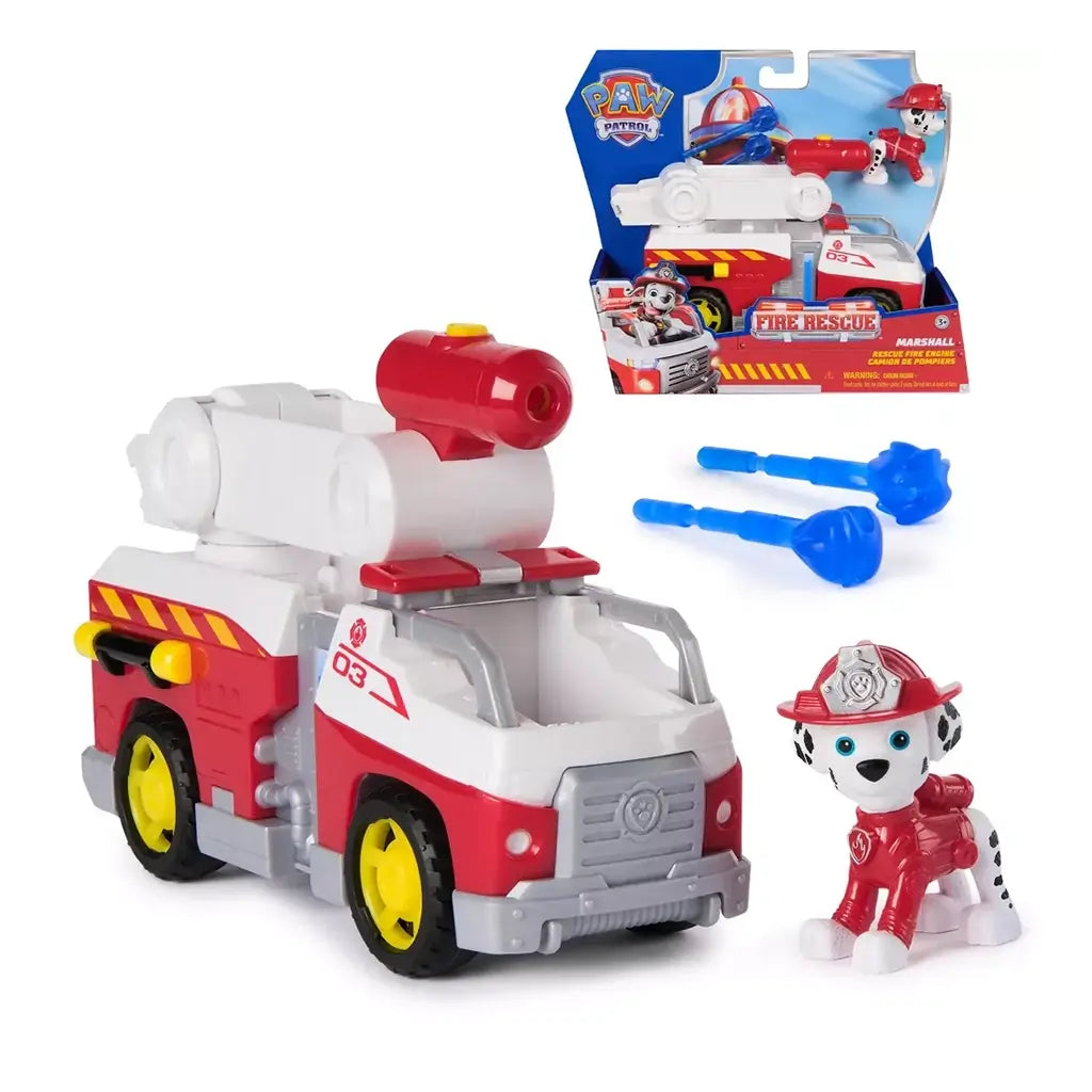 PAW Patrol fire rescue engine toy set in red and white plastic with yellow wheels, featuring Marshall figure, movable ladder launcher, and blue projectiles displayed against retail packaging backdrop.