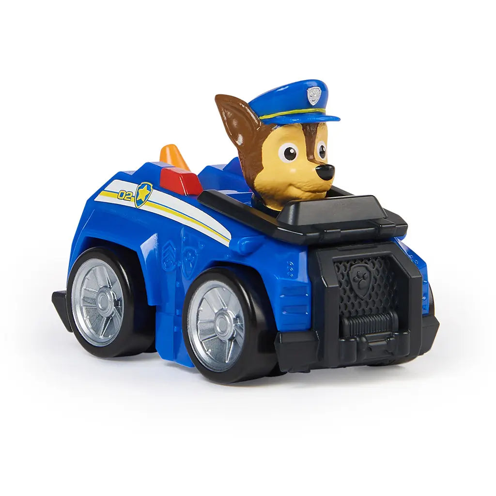 Paw Patrol Chase racer toy in blue plastic with glossy finish, silver wheels, and brown pup character wearing blue police cap, angled three-quarter view highlighting compact design, isolated on a white studio background