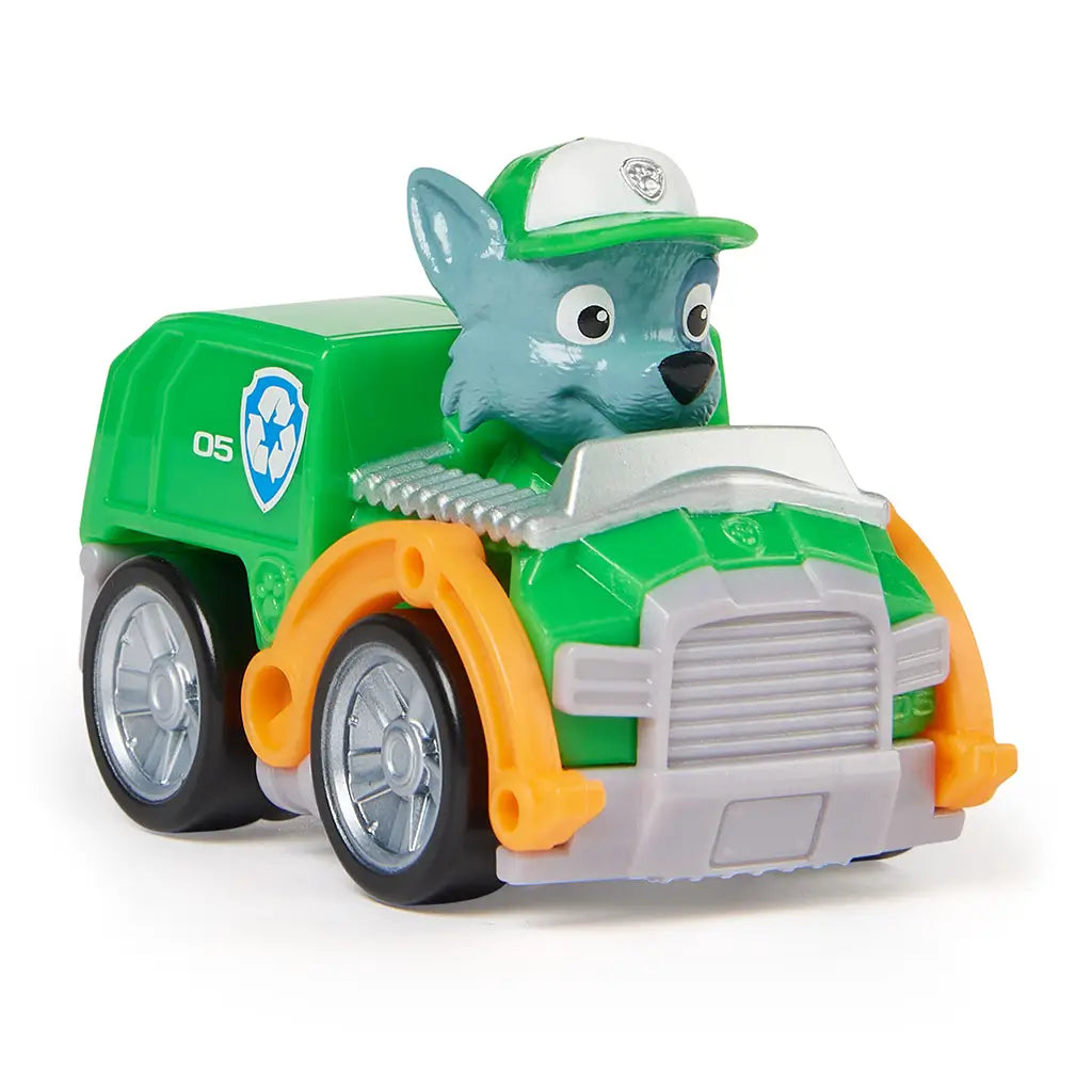 Paw Patrol Rocky racer toy in green plastic with glossy finish, silver wheels, and gray pup character wearing green cap, angled three-quarter view highlighting compact recycling design, isolated on a white studio background