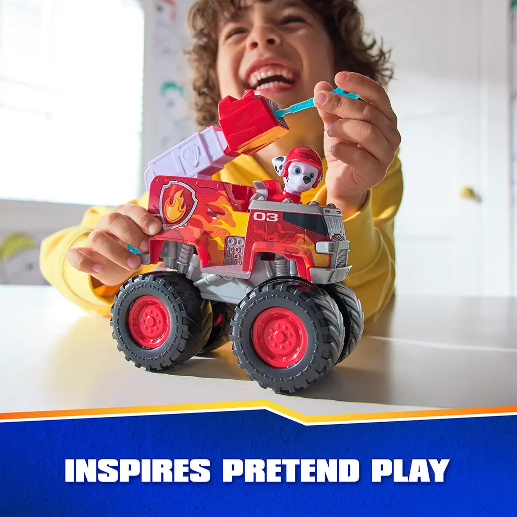 PAW Patrol Marshall fire truck toy features bright red plastic body with flame graphics, smooth and textured surfaces, oversized wheels, and character figure, used by child during imaginative pretend play indoors.