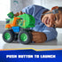 PAW Patrol Rocky recycle truck toy displays bright green plastic body with smooth finish, oversized wheels, and push-button launcher feature, demonstrated by a child during interactive tabletop play activity.