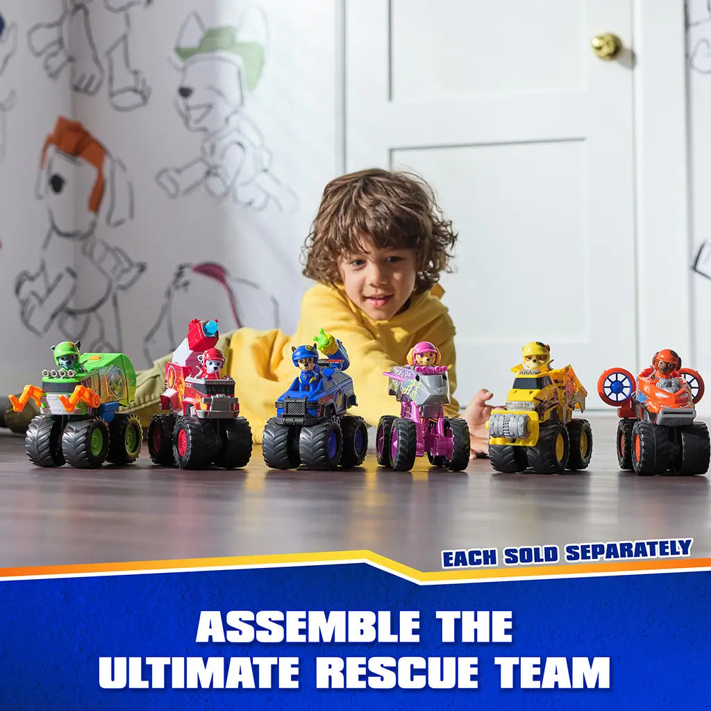 PAW Patrol Rescue Wheels toy set features multiple colorful plastic vehicles with chunky wheels and character figures, arranged in a row on a tabletop with child playing in a bright indoor room.