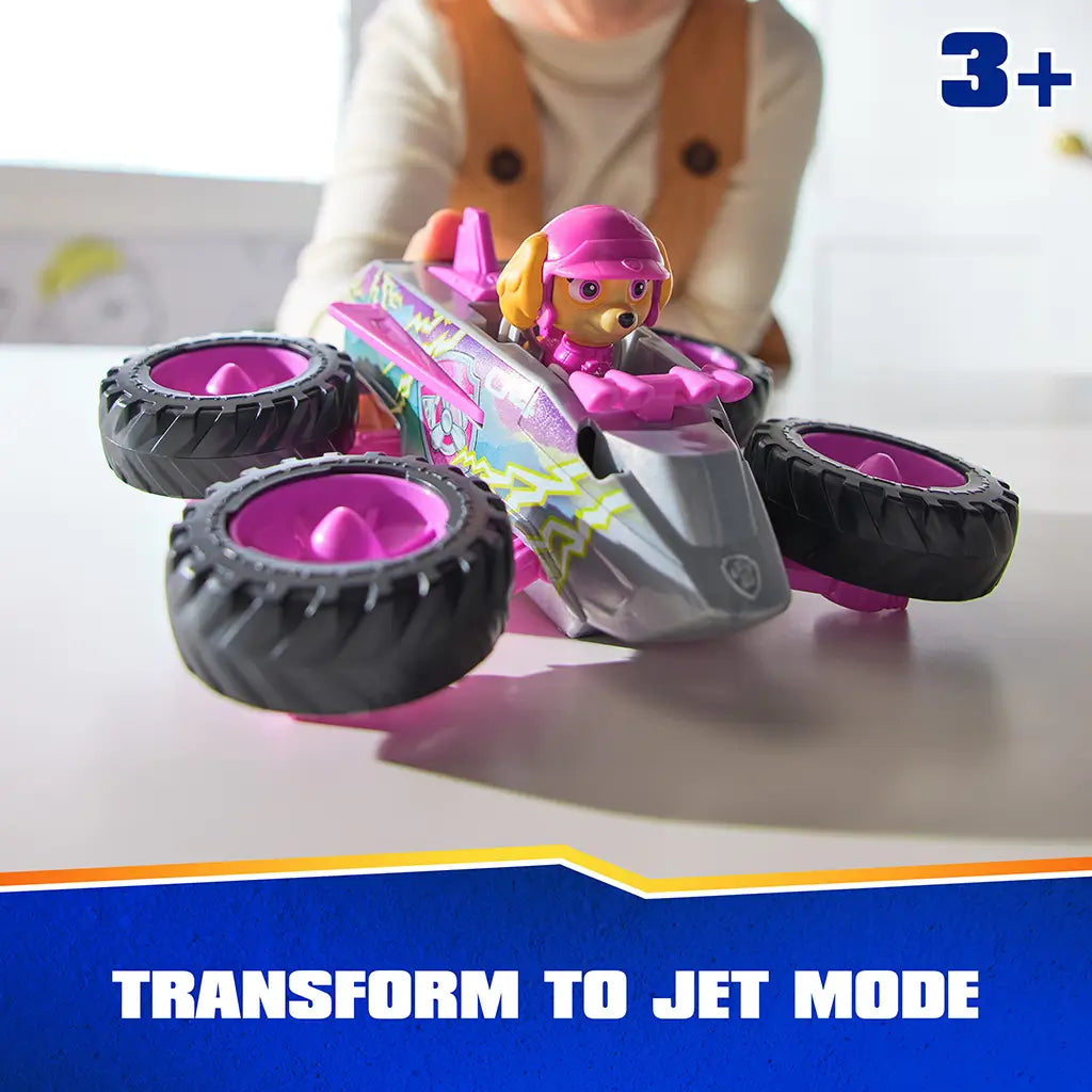 PAW Patrol Skye transforming jet toy features pink and gray plastic body with smooth texture, winged aircraft form, and oversized wheels rotated outward, demonstrating jet mode on a tabletop surface.