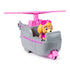 Angled view of Paw Patrol Skye helicopter toy with Skye pup seated in cockpit, gray body with pink accents, paw badge details, and large pink rotor on top.