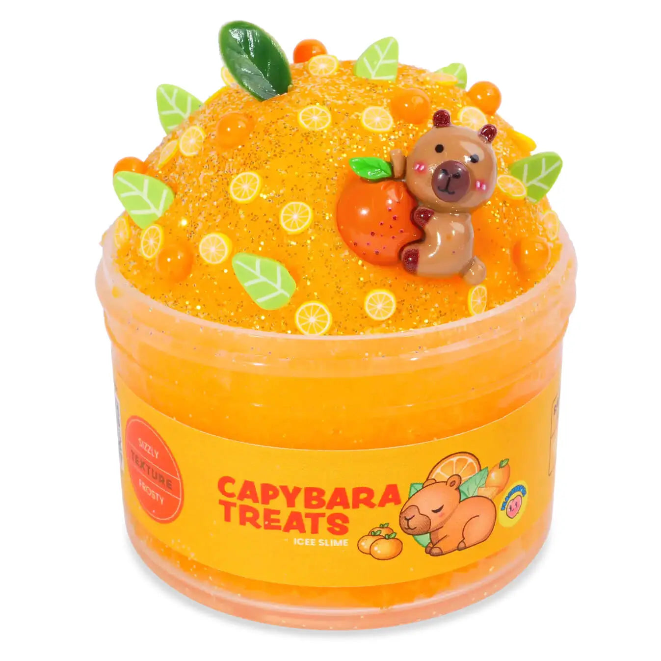 Bright orange icee slime with a textured, fizzy look, topped with a capybara figurine holding an orange, citrus slice confetti, and green leaf charms, packaged in a jar labeled Capybara Treats Icee Slime.