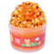 Bright orange cloud slime with a fluffy texture, topped with a cute fox figurine, heart confetti, leaf shapes, and white stars, packaged in a jar labeled Fox Fur Cloud Slime.