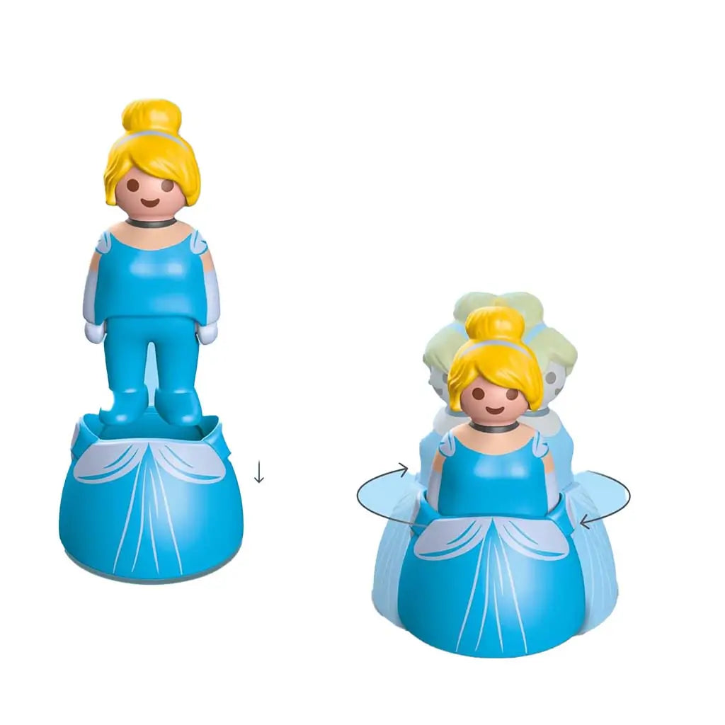 A Playmobil Cinderella figure in bright blue plastic shows a two-part design where the upper body lowers into the gown and rotates, demonstrating the toy’s simple transformation and child-friendly movement feature.