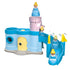 A Playmobil Cinderella figure moves through a pastel pink tower and down a curved blue slide, illustrating the toy’s drop-and-glide feature with flowing motion arrows guiding the character’s playful descent.