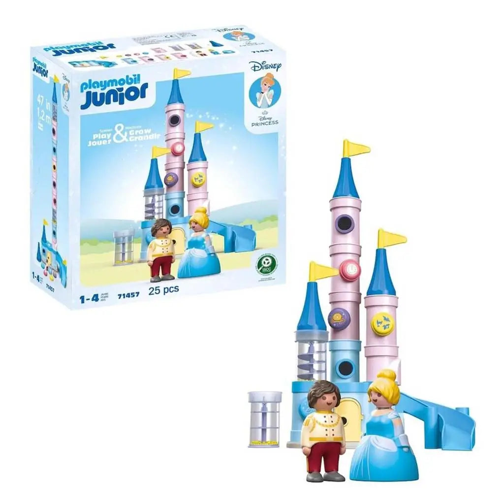 Playmobil Junior Disney Princess castle set shows pastel blue and pink towers with yellow flags and Cinderella and Prince figures, displayed beside the product box to highlight the 25-piece imaginative play kit.