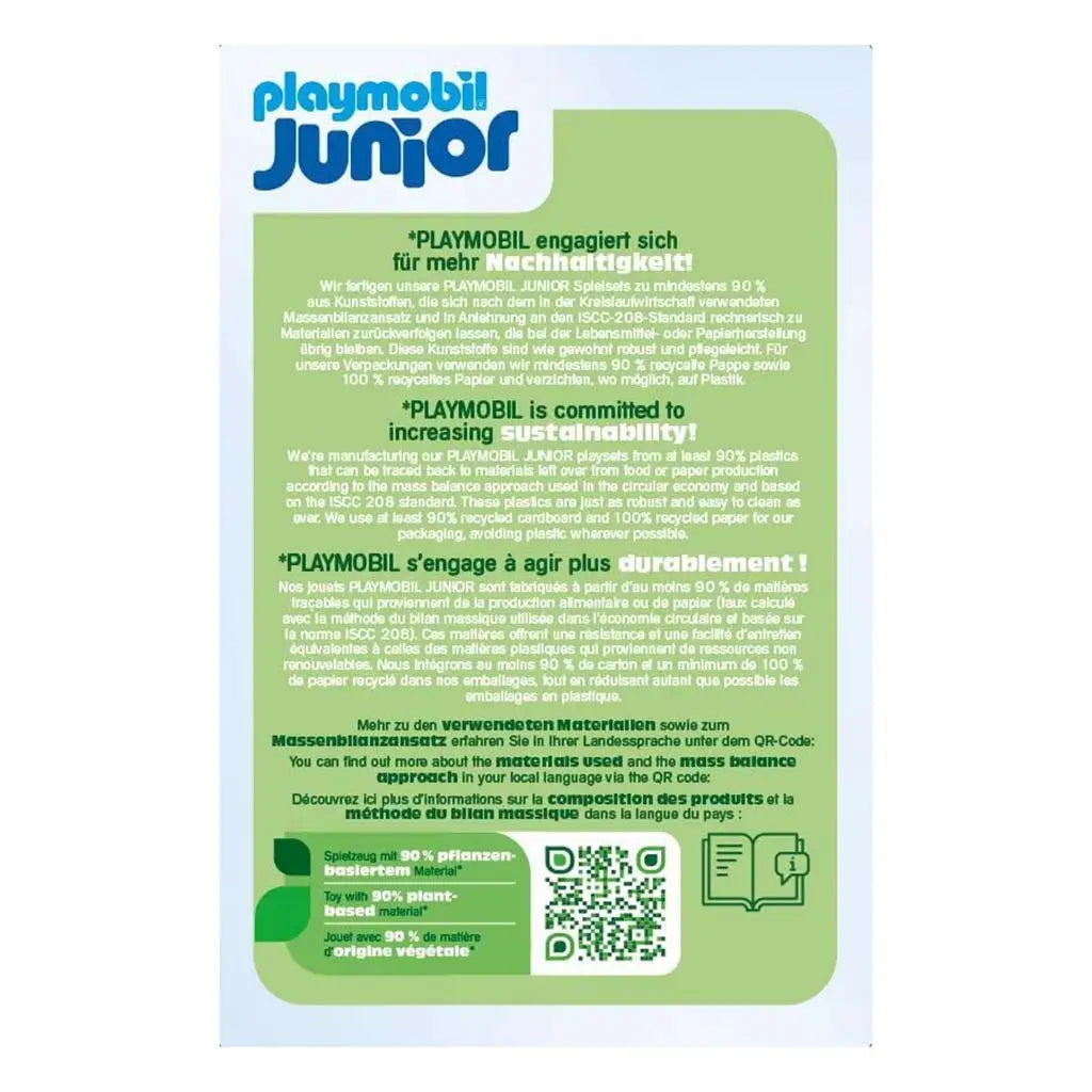 Playmobil Junior sustainability panel with multilingual green text describing plant-based materials, recycled packaging use and QR code access, set on a simple white background with soft blue header.