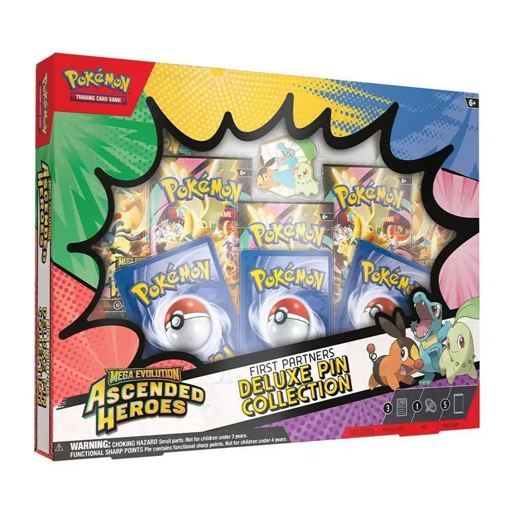 Pokemon TCG box set bright multicolor cardboard packaging with window display and printed graphics, First Partners Deluxe Pin Collection showing booster packs, cards, and pin contents against white studio background