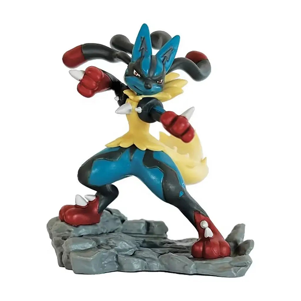 Mega Lucario collectible figure depicts the Pokémon in a dynamic battle stance with blue and black armor-like markings, red gloves and rocky base sculpted in textured gray for display.