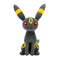Pokémon Umbreon plush shows dark gray fabric with a soft velvety texture, slender feline-like form with bold yellow ring accents, conveying a sleek collectible theme against a simple white backdrop.