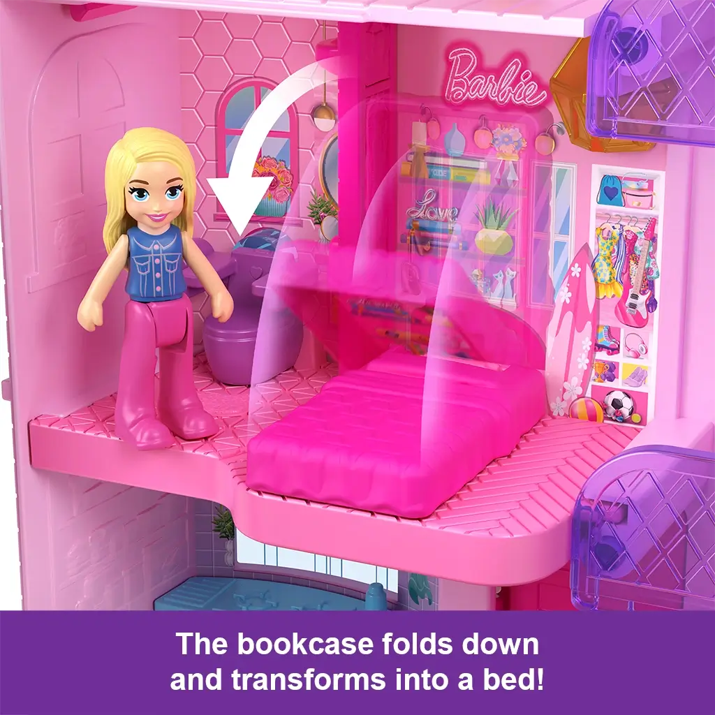 Close-up of Polly Pocket Barbie Dreamhouse bedroom shows pink fold-down bookcase transforming into a bed with doll standing nearby in vibrant miniature setting.