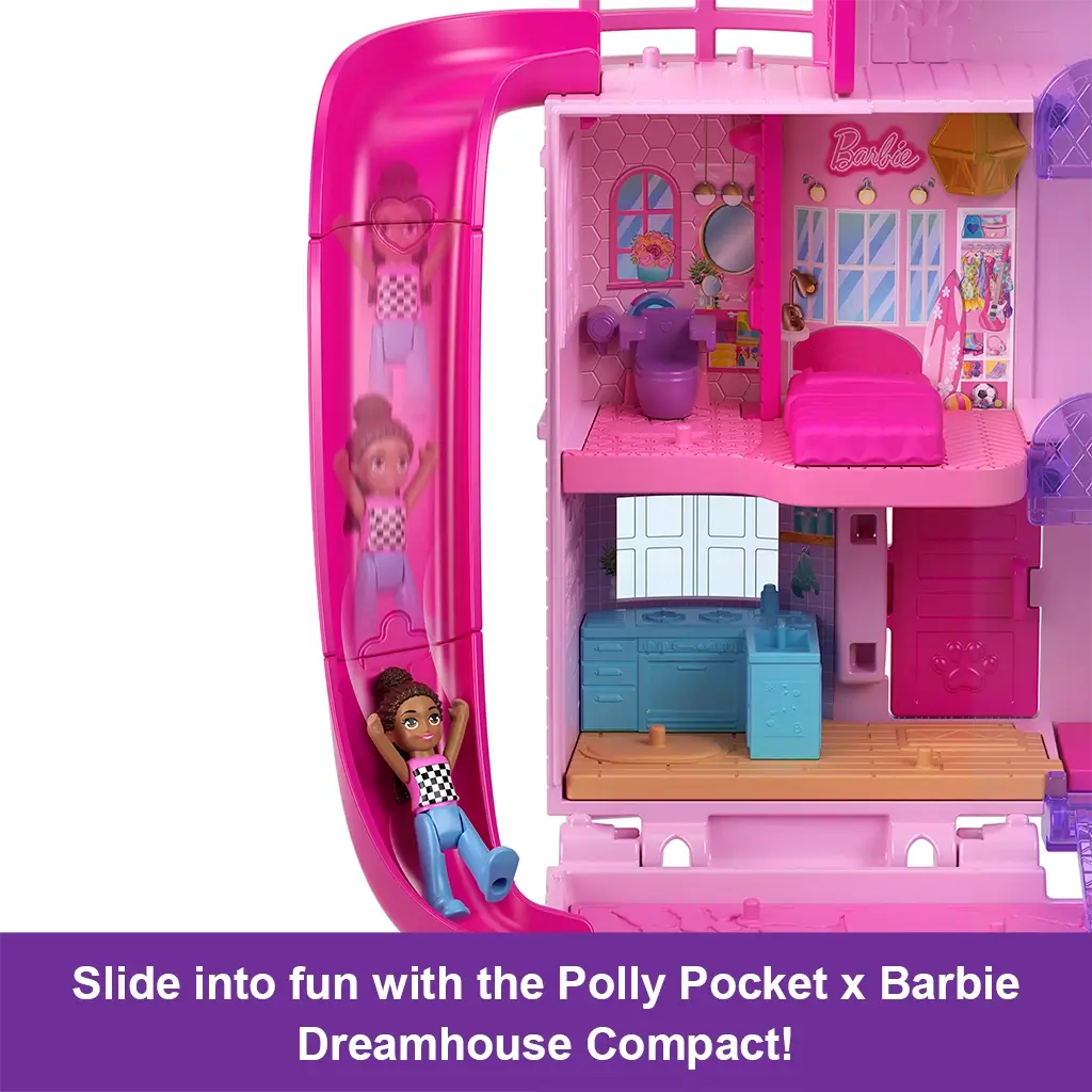 Interior view of Polly Pocket Barbie Dreamhouse Compact with doll sliding down a bright pink curved slide from upper floor into play area beside kitchen space.