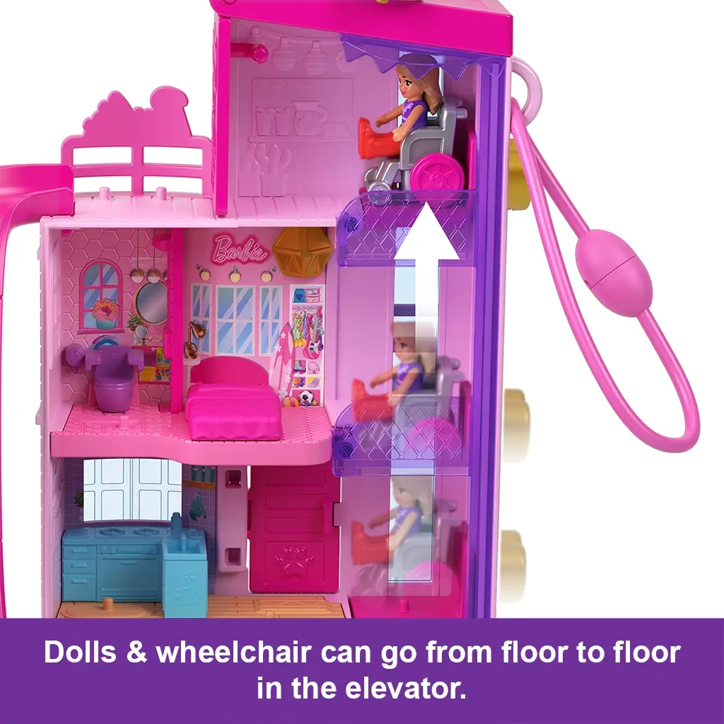 Pink Polly Pocket Barbie Dreamhouse Compact interior shows doll in wheelchair using a clear purple elevator to travel between floors with accessible play design.