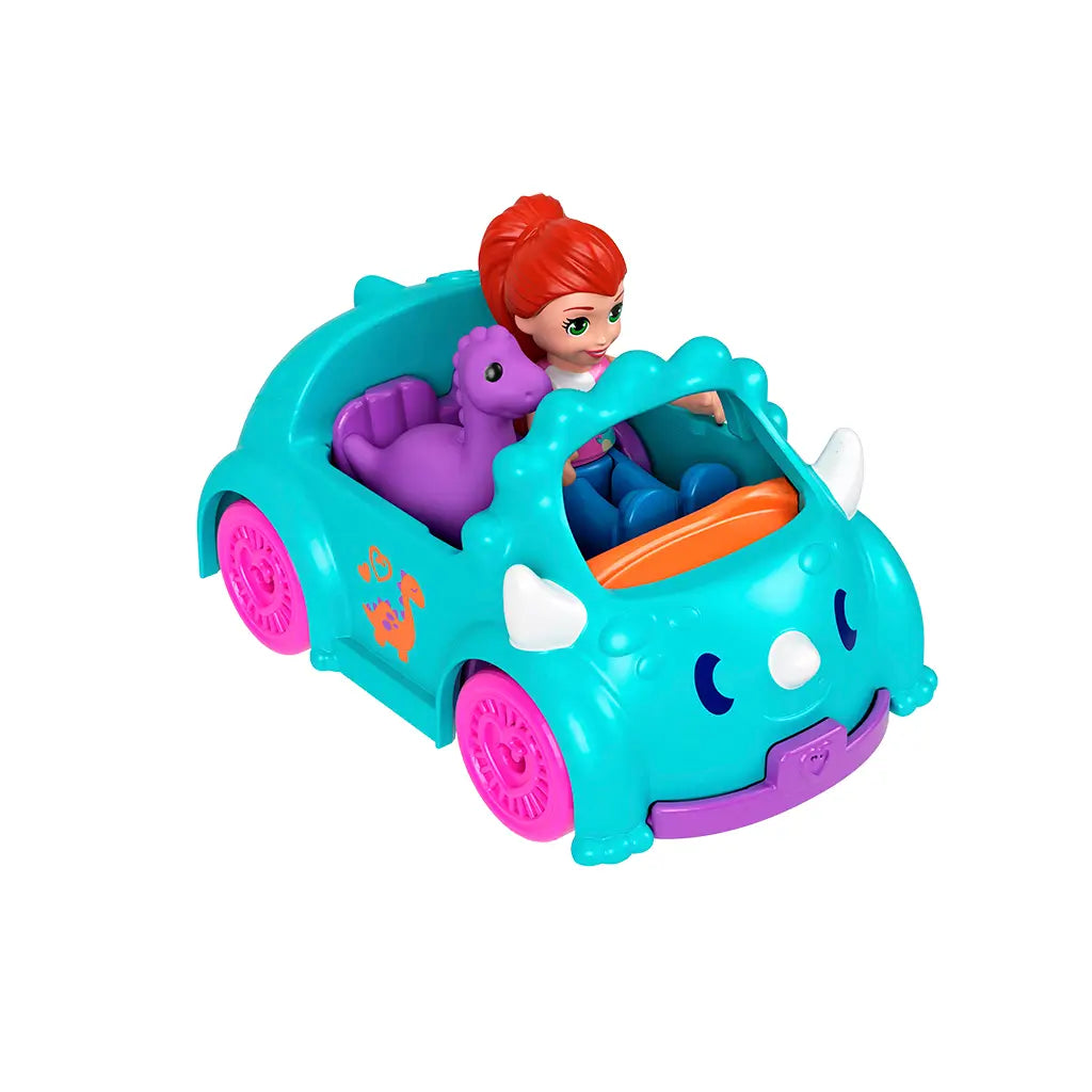 Polly Pocket red-haired doll driving a teal triceratops-shaped toy car with pink wheels, accompanied by a purple brontosaurus passenger, both sitting inside the two-seater vehicle.
