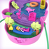 Polly Pocket playset interior showing purple base with water area, hammock between palm trees, flamingo, turtle, and doll relaxing under a tropical jungle backdrop.