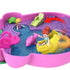 Close-up of Polly Pocket compact pool scene with dolls, banana boat, and pink dolphin, surrounded by palm trees, lounge chairs, and water play areas in vibrant colors.