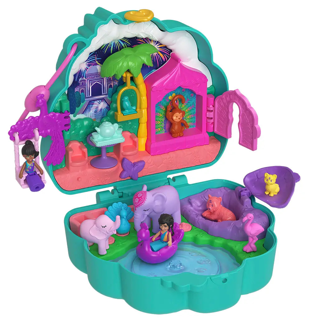 Open Polly Pocket Peacock Garden playset with dolls, peacock swing, animals, and palace garden scene under a night sky backdrop.