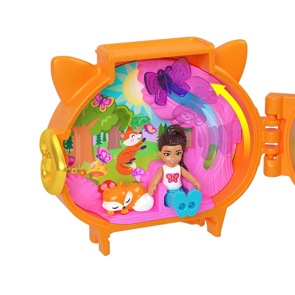Open Polly Pocket fox locket playset with doll figure seated inside colorful pink woodland background, accompanied by a small sleeping fox toy and butterflies for imaginative storytelling.