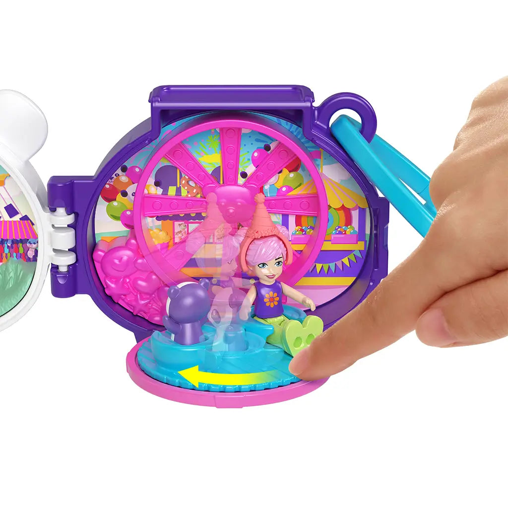 Close-up of Polly Pocket panda locket playset showing interactive Ferris wheel ride with bright pink, purple, and blue parts as small Polly doll figure spins inside a carnival background.
