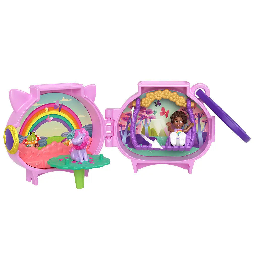 Fully opened Polly Pocket unicorn locket playset with dual scenes: rainbow meadow with unicorn figure and whimsical forest with doll swinging under floral arch.