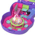 Interior of Polly Pocket Sleepover Puppy playset showing rotating green and pink table with pizza graphics, toy dog, and mini furniture pieces.