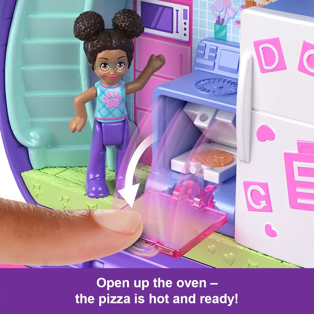 Close-up of Polly Pocket doll beside compact’s kitchen oven with interactive feature showing pizza baking inside, highlighted by arrow animation.