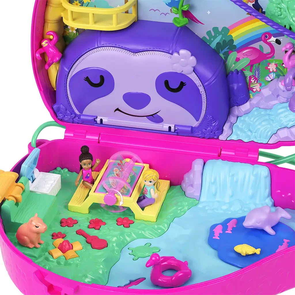 Open Polly Pocket Sloth Family compact playset features picnic table with dolls, miniature campfire, guitar, and waterfall scene, all enclosed in a pink sloth-shaped carry case.