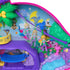 Close-up of Polly Pocket jungle compact playset with doll figure sliding on a purple zipline among colorful rainforest animals, trees, and illustrated background details.