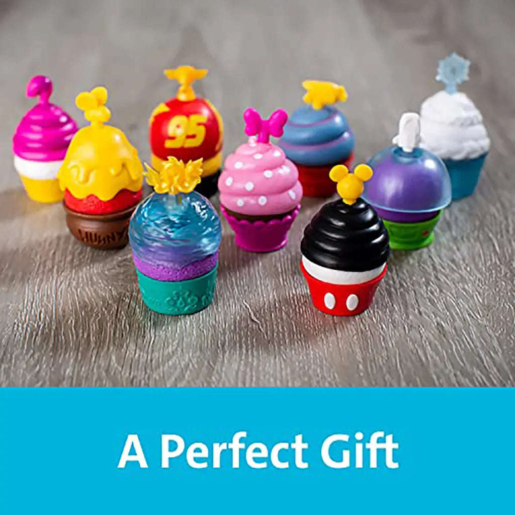 Disney Enchanted Cupcake Party toy cupcakes in bright colors, designed with character-inspired toppers and frosting, displayed on wooden surface with text 'A Perfect Gift.'