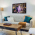 Modern living room with framed Ravensburger Disney Villainous Evil Queen puzzle artwork on the wall, showing purple design and classic Snow White scenes as decorative wall art.